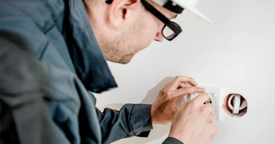An electrician working on wiring