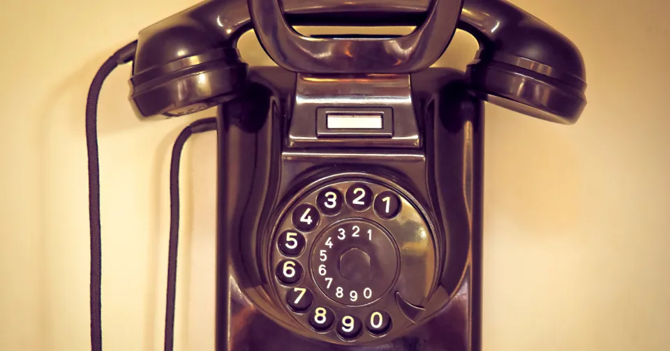 A vintage telephone handset on a desk