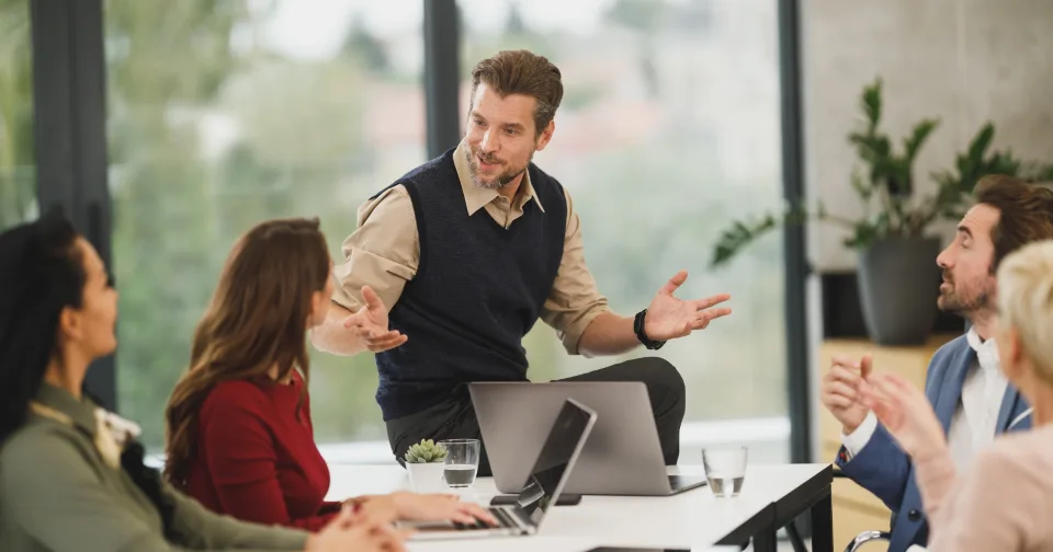 Colleagues talking through a question in a meeting