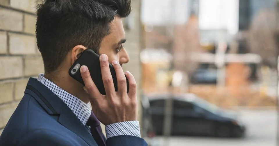 A person taking a business call on a mobile phone