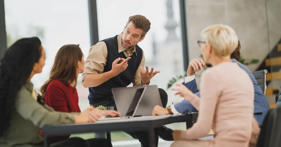 Someone presenting to colleagues in a meeting room
