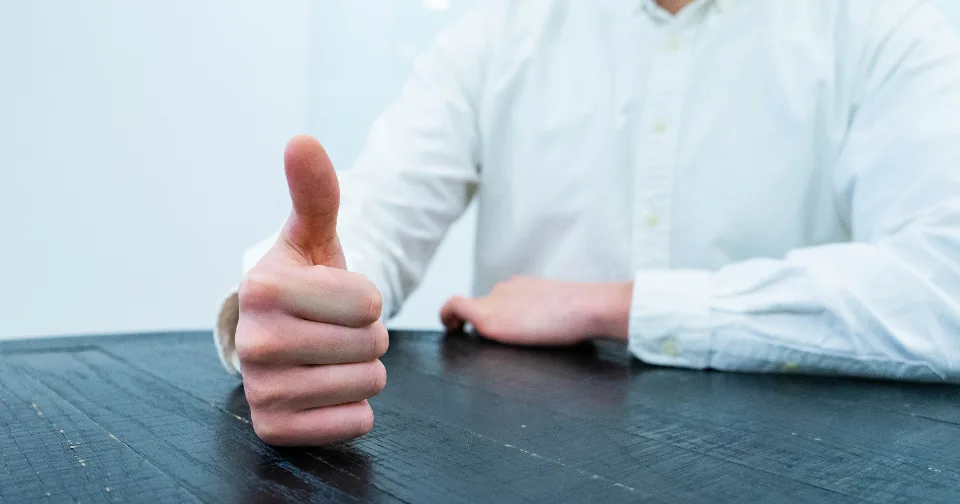 A customer giving a thumbs up in approval