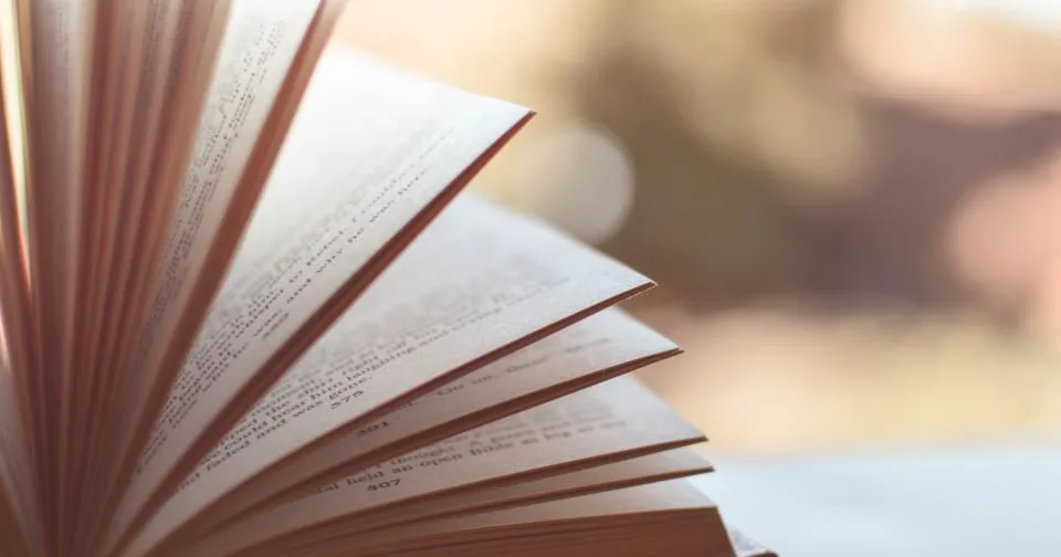 An open book and notes, reading to learn a new skill