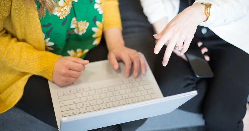Two colleagues working together at a laptop